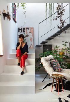 a woman sitting on the stairs in her home