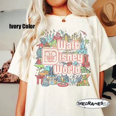 a woman wearing a white tshirt with the words walt world printed on it