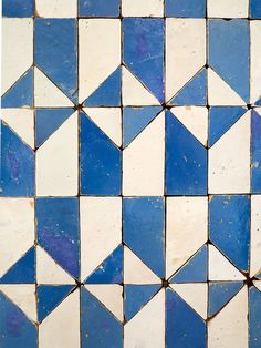 a blue and white tiled floor with small triangles