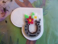 this is a cross - stitch pattern for a mickey mouse brooch with flowers on it