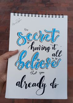 someone is holding up a notebook with the words, secret having to believe that you already do