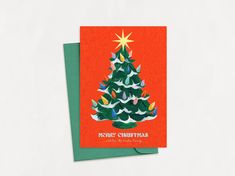 a christmas card with an image of a tree on the front and green envelopes