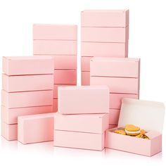 there are many pink boxes that have donuts in them