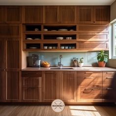 a kitchen with wooden cabinets and white dishes on the counter top, in front of a window