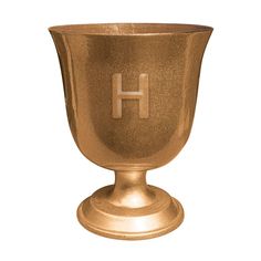 a golden cup with the letter h on it