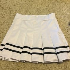 This Skirt From Spirit Halloween (Size M) Is The Perfect Skirt For A Cheerleader Costume. It Was Worn Once, And Never Worn Again So It’s Practically Brand New! Its Elastic Waistband Makes It Snug But Doesn’t Make It Hard To Breathe. The Pleats Flow Nicely When Walking Or Spinning, And They Are Not See-Through. It’s Perfect For An Everyday Outfit Or Halloween! Black Cheerleaders, Hard Breathing, Cheerleader Costume, Skirts White, Everyday Outfit, White Skirts, Spirit Halloween, Cheerleading, Everyday Outfits