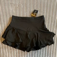 Black / Ruffles / Shorts Under That Also Have Ruffles / Never Worn / Spandex Like Material / Very Comfy Casual Party Skort In Elastane, Casual Elastane Skort For Party, Stretch Elastane Shorts For Night Out, Elastane Mini Skirt In Solid Color, High Waist Stretch Swim Skirt For Party, Black Stretch High Waist Skort, Fitted Black Short Skort, Summer Black Mini Skirt With Wide Waistband, Black Mini Skirt With Wide Waistband For Summer