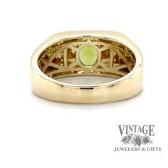 This ring features a bezel-set oval Peridot weighing approximately 1.3 carats, accented by ten 1.3mm round diamonds. 10k yellow gold size 11 7.9 grams Yellow Gold Jewelry With Gemstone In Wide Band, Yellow Gold Wide Band Jewelry With Gemstone, Collectible Yellow Gold Jewelry With Accent Stones, Modern 14k Gold Collectible Jewelry, Collectible Modern 14k Gold Jewelry, Gold Oval Signet Ring With Accent Stones, Yellow Gold Wide Band Jewelry With Bezel Setting, Yellow Gold Jewelry With Bezel Setting In Wide Band, Modern 14k Gold Jewelry With Accent Stones