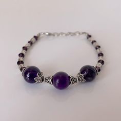 Fashionable Purple Beats With Silver Tone Bracelet. New Condition. Silver Round Beaded Bracelets With Extender, Silver Round Beaded Bracelet With Extender, Silver Amethyst Bracelets With Round Beads, Adjustable Silver Amethyst Bracelets, Silver Amethyst Beaded Bracelets, Elegant Silver Amethyst Beaded Bracelets, Spiritual Silver Jewelry With Extender, Handmade Ankle Bracelets, Penny Bracelet