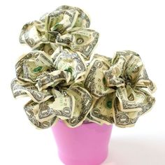 a pink vase filled with lots of money