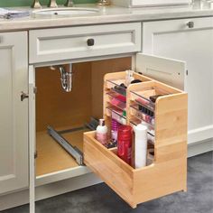 an open cabinet in a kitchen filled with beauty products