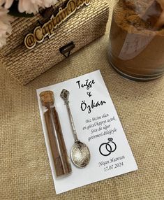 a couple of spoons sitting on top of a piece of paper next to a jar