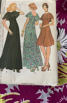 two women's dresses, one in black and the other in green