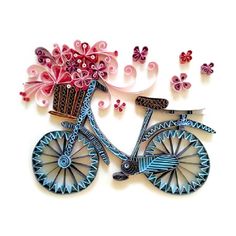 a decorative brooch depicting a bicycle with flowers in the basket and butterflies around it