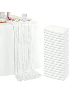 a stack of white napkins sitting on top of a table next to each other