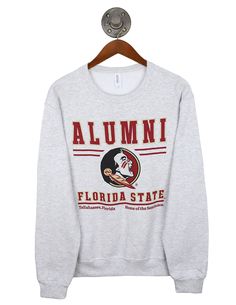 Crew Neck T-shirt With University Logo For Fall, Varsity Graphic Print Top For Fan Gear, Sporty Tops With University Logo For Sports Events, Varsity Logo Print Top For Game Day, Varsity Tops With Logo Print For Game Day, Team Spirit Logo Print Sweatshirt For Game Day, Team Spirit Sweatshirt With Logo Print For Game Day, Team-colored Sweatshirt With Team Logo For Fans, Team-colored Sweatshirt With Team Logo