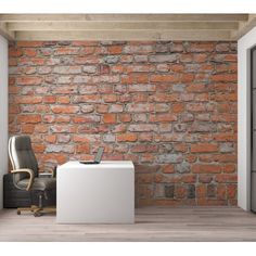 an office with a brick wall in the background and a chair next to it on a hard wood floor