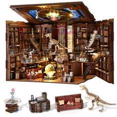 a room with bookshelves, couches and dinosaurs in it