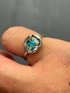 This Enamel Reef Ring is made from Sterling Silver, 22ct gold leaf and blue and green turquoise enamel. The ring has been water-cast which is when silver is melted and dropped into water. Each piece is therefore completely unique. This ring is a Size N but can be taken up to Size O. The band measures approximately: 2.5mm  in width and the enamelled unit measures approximately: 9mm in width.  If you need a different size I can of course make another ring which will  be very similar but unique in Sea Ring, Sea Rings, Ocean Ring, Enamel Jewellery, Sea Lover, Ocean Lover, Enamel Ring, Ring Blue, Jewellery Gift