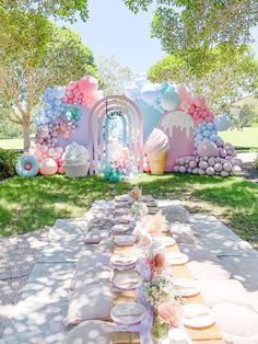 a table set up for a party with cupcakes and desserts