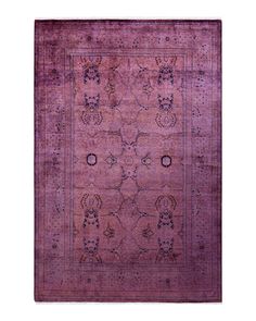 a purple rug with an intricate design on the top and bottom, in front of a white background