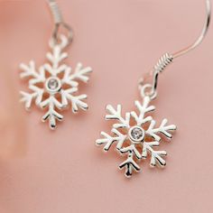 Indulge in the exquisite beauty of these stunning snowflake sterling silver dangle drop earrings, delicately crafted with 925 solid sterling silver and adorned with sparkling cubic zirconia. The intricate snowflake design exudes elegance and adds a touch of grace to your ensemble. Lightweight and comfortable, these earrings are the perfect present to show your loved ones how much they mean to you during the festive Christmas and holiday season. Embrace the magic of the snowflakes with these dazz Snowflake Shaped Sparkling Sterling Silver Jewelry, Sparkling Snowflake Jewelry In Sterling Silver, Sparkling Snowflake Sterling Silver Jewelry, Elegant Sterling Silver Snowflake Jewelry, Silver Snowflake Sterling Silver Jewelry, Silver Sterling Snowflake Jewelry, Sterling Silver Dangle Diamond Earrings Gift, Sterling Silver Snowflake Earrings, Silver Snowflake Cubic Zirconia Earrings