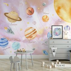 a child's room with planets and stars on the wall