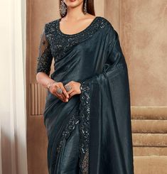 COLOR : Shimmer Peacock Black FABRIC : Saree - Fancy Silk, Blouse - Fancy Silk & Net WORK : Resham Embroidery, Stones, Sequins, Lace BorderOCCASION : Wedding, Engagement, Party Wear, Festival, Sangeet NOTE : The outfit includes blouse and saree only. Petticoat is not included. READY-TO-WEAR : No STITCHING : Available as semi-stitched fabric, can be stitched using standard size option (+$30). Note: There might be a slight color variation due to lighting and flash used during photoshoot. The brigh Formal Festive Pre-draped Saree With Intricate Embroidery, Party Blouse Piece With Intricate Embroidery On Dola Silk, Festive Party Wear Blouse With Intricate Embroidery, Wedding Embellished Art Silk Embroidered Fabric, Semi-stitched Embellished Art Silk Saree, Embellished Art Silk Semi-stitched Saree, Embellished Semi-stitched Art Silk Saree, Wedding Embellished Chanderi Blouse Piece, Elegant Embroidered Embellished Art Silk Fabric