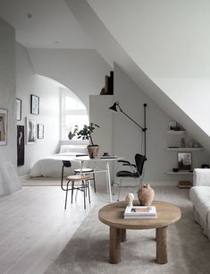 a living room filled with furniture and white walls