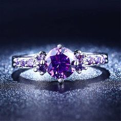 a purple ring sitting on top of a blue surface with the words mean written above it