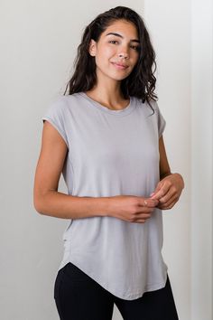 A classic boyfriend bamboo tee with a feminine twist. This universally flattering style can be worn with skirts, pants, or leggings and is a perfect base for any wrap or jacket. Scoop neck, cap sleeve, relaxed fit. High-low curved hemline. Below hip length. Boyfriend Tshirt, Cap Sleeve Shirt, Silk Outfit, Wrap Jacket, Long Torso, Sleeveless Tunic, Casual Design, Womens Size Chart, Skirt Leggings