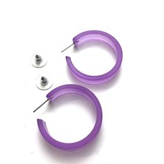 Lilac or pastel purple frosted lucite hoop earrings in a straight & sturdy shape. This style is known as the 'Portland Hoop' (named after the maker's home in Portland, Maine) and comes in 2 sizes. The smaller of the 2 is called the "Chandler Hoop' and also comes in loads of colors. The Portland measures about 36mm or 1.5" in diameter & 10mm in width. One of our largest styles & yet it's still super lightweight. Jewelry is designed & hand finished by us, here in the US. Most all a Adjustable Small Purple Hoop Earrings, Purple Small Hoop Earrings, Purple Hoop Earrings For Pierced Ears, Purple Small Hoop Earrings For Pierced Ears, Small Purple Hoop Earrings For Pierced Ears, Hypoallergenic Purple Hoop Earrings, Surgical Steel Earrings, Portland Maine, Vintage Lucite