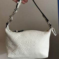 This Coach Pebble Leather Baguette Bag Is In New, Unused Condition From A Smoke-Free Home. The Bag Features A Warm White Color With Silver-Tone Hardware, And A Buttery Soft Pebble Leather Exterior. The Interior Is A Clean, Unused, Black Fabric With A Pocket, A Great Addition To Any Collection, It’s A True Coach Classic. D: 7.5" X 5" X 4". Strap Length: 11". Luxury Baguette Bag For Errands, Luxury Leather Baguette Bag For Errands, Luxury Everyday Baguette Bag Pouch, Textured Leather Rectangular Baguette Bag For Travel, Designer Everyday Baguette Clutch, Designer White Baguette Bag For Shopping, Everyday Crossbody Baguette Bag With Silver-tone Hardware, Everyday Baguette Crossbody Bag With Silver-tone Hardware, Everyday Use Baguette Bag With Silver-tone Hardware