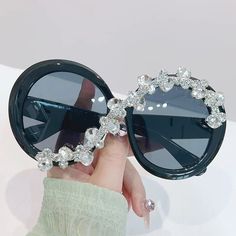 Introducing our exquisite Oversized Round Sunglasses, adorned with sparkling gemstones. The luxury design exudes elegance and sophistication, perfect for any occasion. Protect your eyes with UV400 coverage while making a statement with these diamond decorated bling sunglasses. Indulge in pure luxury with our Oversized Round Sunglasses. Dazzling gemstones adorn these sunglasses, making them the epitome of elegance and sophistication. Not only do they exude style, but they also provide UV400 coverage for ultimate eye protection. Make a statement at any occasion with these bling sunglasses. Frame Material: Plastic Lenses Material: Plastic Lenses Optical Attribute: UV400 Lens Height: 58 mm Lens Width: 58 mm Goggles Women, Bride With Glasses, Bling Sunglasses, Round Sunglasses Men, Photography Decoration, Round Sunglasses Vintage, Sunglasses Oversized, Oversized Round Sunglasses, Rhinestone Sunglasses