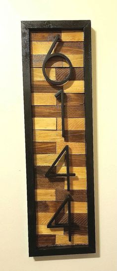 a wooden sign that has the number four on it and is made out of strips of wood