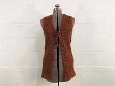 Chest: 34" Bottom Hem: 36"  Length: 31" Material: 100% acrylic Brand: Helen Sue Adorable brown and orange knit cardigan vest with a bow in the front. Super cute and in great condition. Fabric has stretch. ✂ All garments measured laying flat. Bust, waist, & hip measurements are already doubled. Please refer to the last photo for the size chart I use to determine modern sizing. ✂ All items are vintage and pre-loved. All major flaws are listed, but small blemishes like loose stitches and buttons may not be in the item description as they are to be expected when purchasing vintage items. ♡ New items are listed every week! Follow instagram.com/checkenginevintage for the latest listings and sales! ♡ All items for sale in this shop are vintage and pre-loved! This means you are receiving something Sleeveless Brown Cardigan For Fall, Brown Knitted Sleeveless Vest, Fitted Orange Vest For Fall, Crochet Sleeveless Sweater Vest For Fall, Fall Crochet Sleeveless Sweater Vest, Net Cardigan, Crochet Net, Orange Knit, Brown And Orange