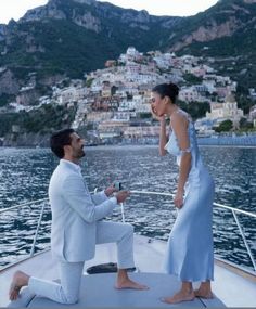 a man and woman on a boat in the water