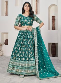 Add a touch of elegance and style to your wardrobe with our Teal Green Weaving Jacquard Dola Silk Lehenga Choli. Made from high-quality fabric, this readymade ensemble is perfect for any Indian wedding or festive occasion. The intricate weaving and jacquard design will surely make you stand out in the crowd. The unstitched blouse can be customized upto 46 inches. Do Note: All the accessories shown are for styling purpose only. Slight color variation may occur due to photographic reasons. Occasio Jacquard Lehenga, Teal Green Blouse, Lehenga Choli Designs, Ghaghra Choli, Lehenga Choli For Women, Silk Lehenga Choli, Choli For Women, Lengha Choli, Green Lehenga