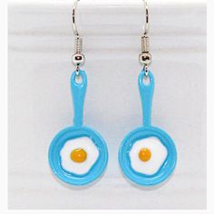 Egg In A Pan” Enamel Earrings Charm Approx. 0.9 Cm (H) X 2.1cm(W) Nickel Free Ear Wires. Comfortable And Light Weight. Rubber Stoppers Included. Earrings Will Come On An Earring Card Novelty Blue Drop Earrings, Blue Hypoallergenic Fun Jewelry, Blue Handmade Novelty Earrings, Handmade Blue Novelty Earrings, Blue Fun Drop Earrings, Fun Blue Nickel-free Earrings, Blue Fun Dangle Jewelry, Blue Drop Earrings Fun Style, Fun Blue Nickel-free Jewelry