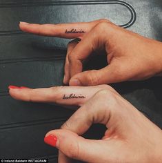 two people with matching tattoos on their fingers