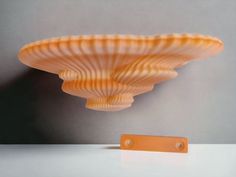 an orange object sitting on top of a white table