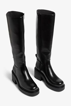 Chunky heeled black faux leather knee-high boots - Black - Monki WW Chunky Black Boots Heels, Leather Knee High Lug Sole Boots, Chunky Heel Knee Boots, Shop Knee High Black Boots, Chunky Heal Black Boots, Chunky Heel Fall Boots, Knee High Leather Boots For Women, Boots Womens Black, Tall Chunky Flat Boots