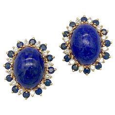 These colourful clip-on-earrings are designed as stylized flowers with a large lapis lazuli cabochon in the centre surrounded by gem set flower petals. Each ear clip is surrounded by twelve round cut sapphires alternating with 12 round cut diamonds. The mount is made out of 14 karat gold. Luxury Formal Clip-on Earrings With Cabochon, Luxury Vintage Cabochon Earrings, Vintage Yellow Gold Clip-on Earrings With Cabochon, Yellow Gold Lapis Lazuli Cabochon Jewelry, Luxury Vintage Cabochon Clip-on Earrings, Gold Clips, Vintage Diamond, Round Cut Diamond, Flower Petals