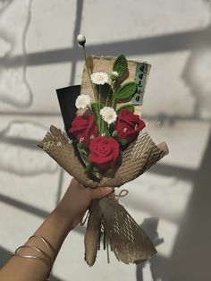 a person holding a bouquet of flowers in their hand