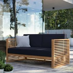 a wooden couch sitting on top of a patio