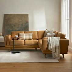 a living room with a couch, chair and rug