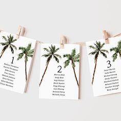 three palm trees are hanging on clothes pins with the names of each wedding day and date