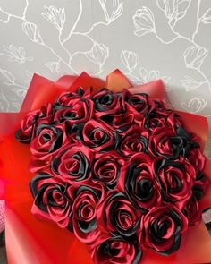 a large bouquet of red and black roses