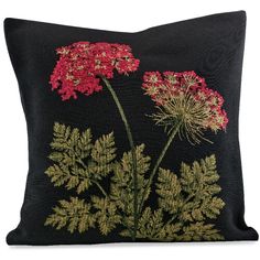 a black pillow with red flowers on it