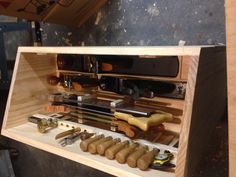 a wooden box filled with different types of woodworking tools on top of a table